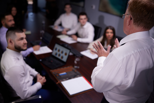 man holding team meeting in conference room